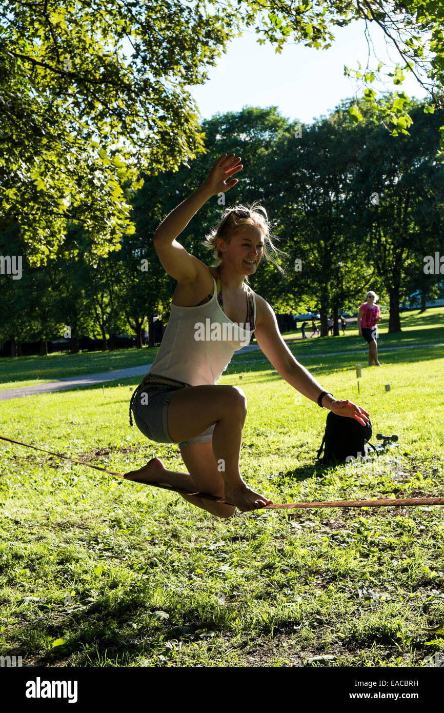Woman balancing on a rope in a park Stock Photo