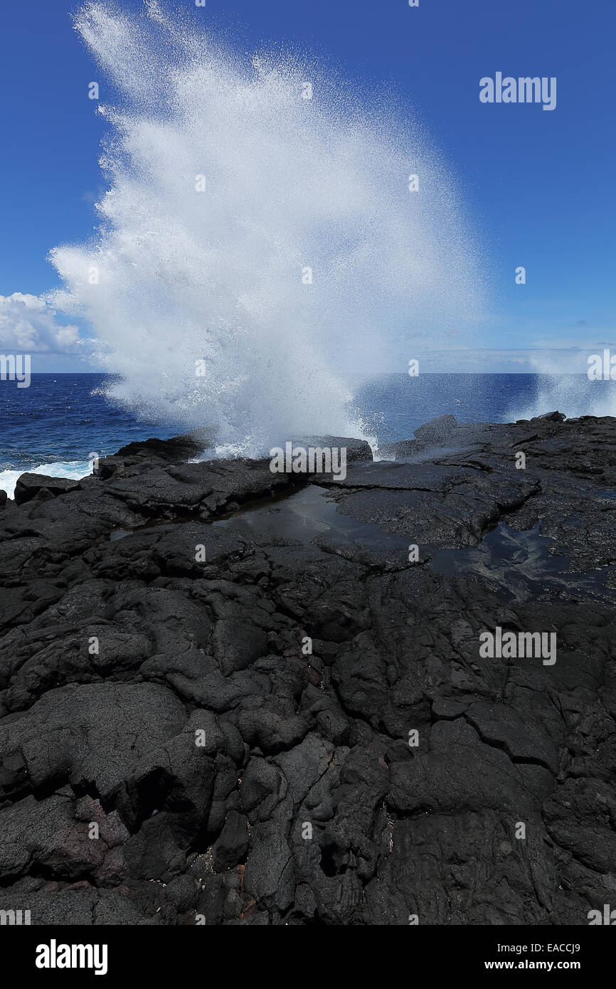 Ocean waves crash on the lava rocky coast of the big island of Hawaii Stock Photo