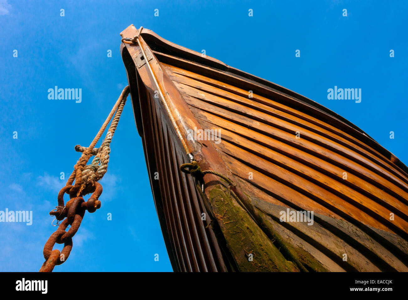 Bow of wooden boat against blue sky in Lynmouth harbor North Devon Stock Photo