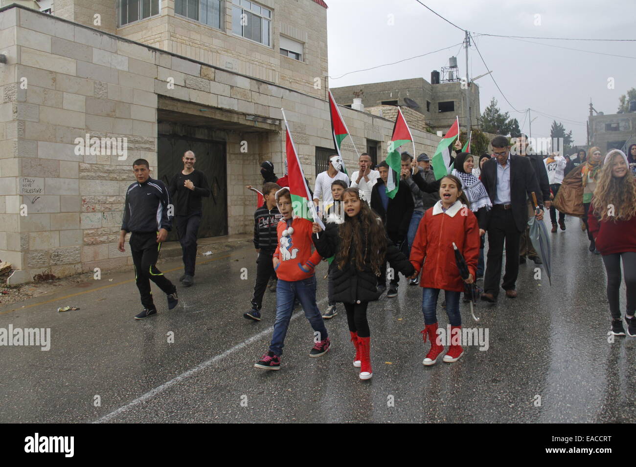 (141111) -- RAMALLAH, Nov. 11, 2014 (Xinhua) -- Palestinian girl Jana Jihad (C) participates in a demonstration against Jewish settlement in a West Bank village on Oct. 30, 2014. Jana has become famous for her reports of stories on social media that she has been named as the youngest amateur reporter in Palestine. Jana said she would like to study in Harvard University in the future and become a professional journalist and writer. 'I dream of a country where there are no checkpoints and no tear gas, where I can go to school freely without interruption. I dream on a country where children are Stock Photo
