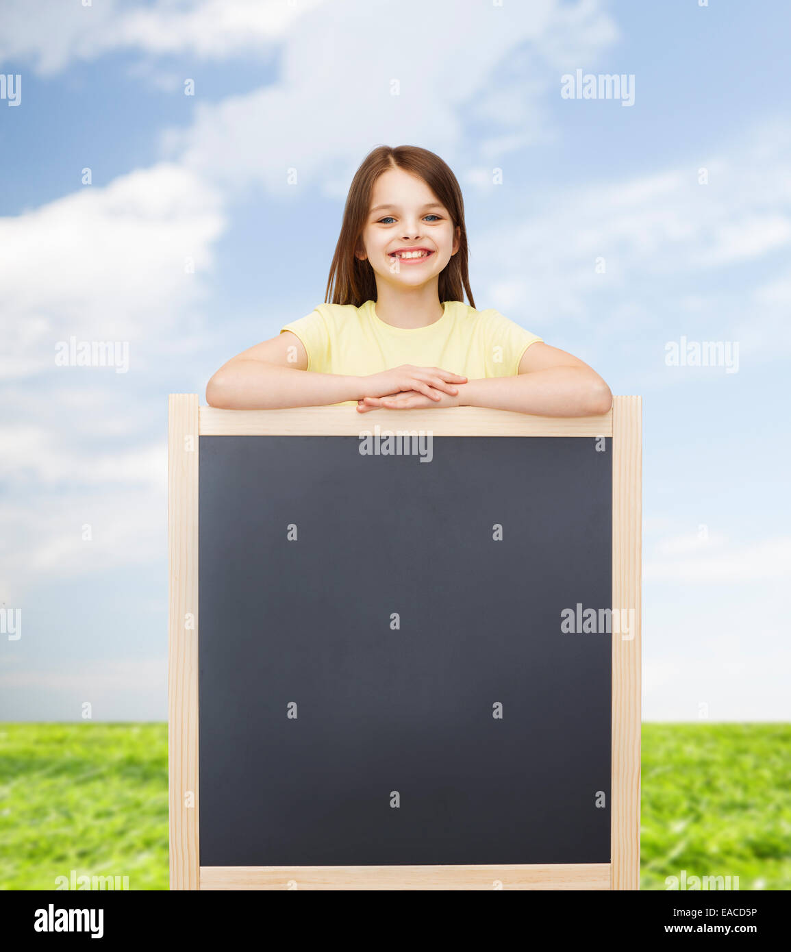 happy little girl with blank blackboard Stock Photo