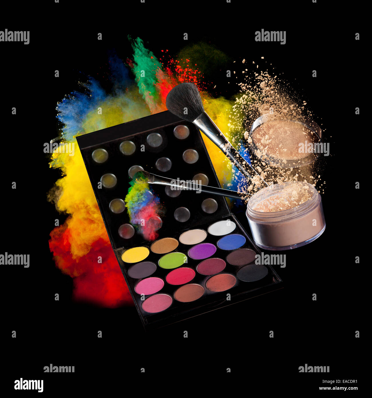 Freeze motion of colored dust explosion make-up palette and brushes, isolated on black background Stock Photo