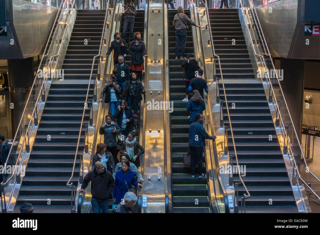 Rail buffs, commuters and the curious arrive via escalator together in the new Fulton Center in Lower Manhattan in New York Stock Photo