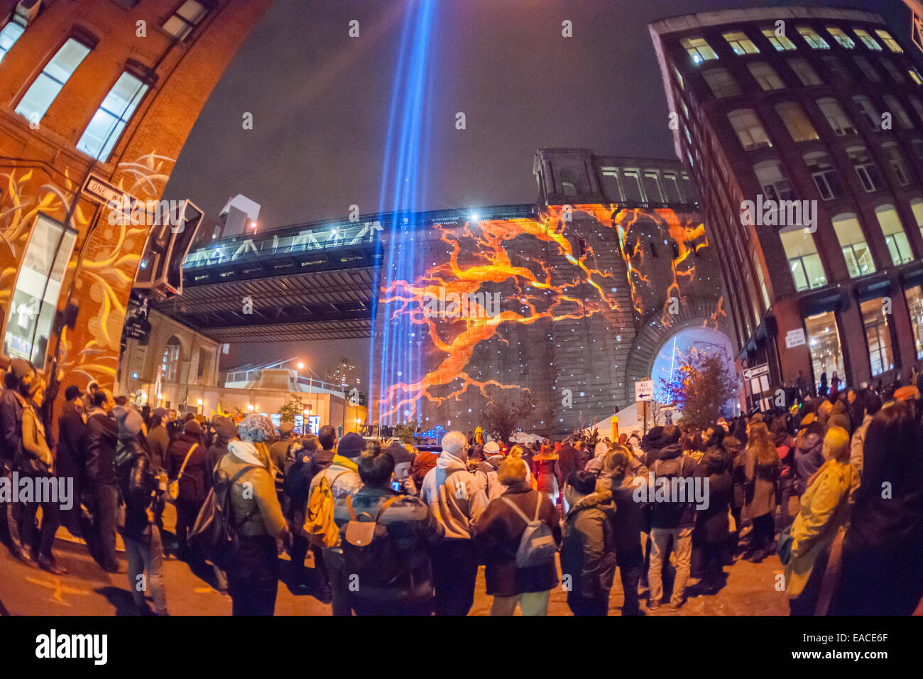 Thousands of visitors watch projections on the Manhattan Bridge during the First New York Festival of Light Stock Photo