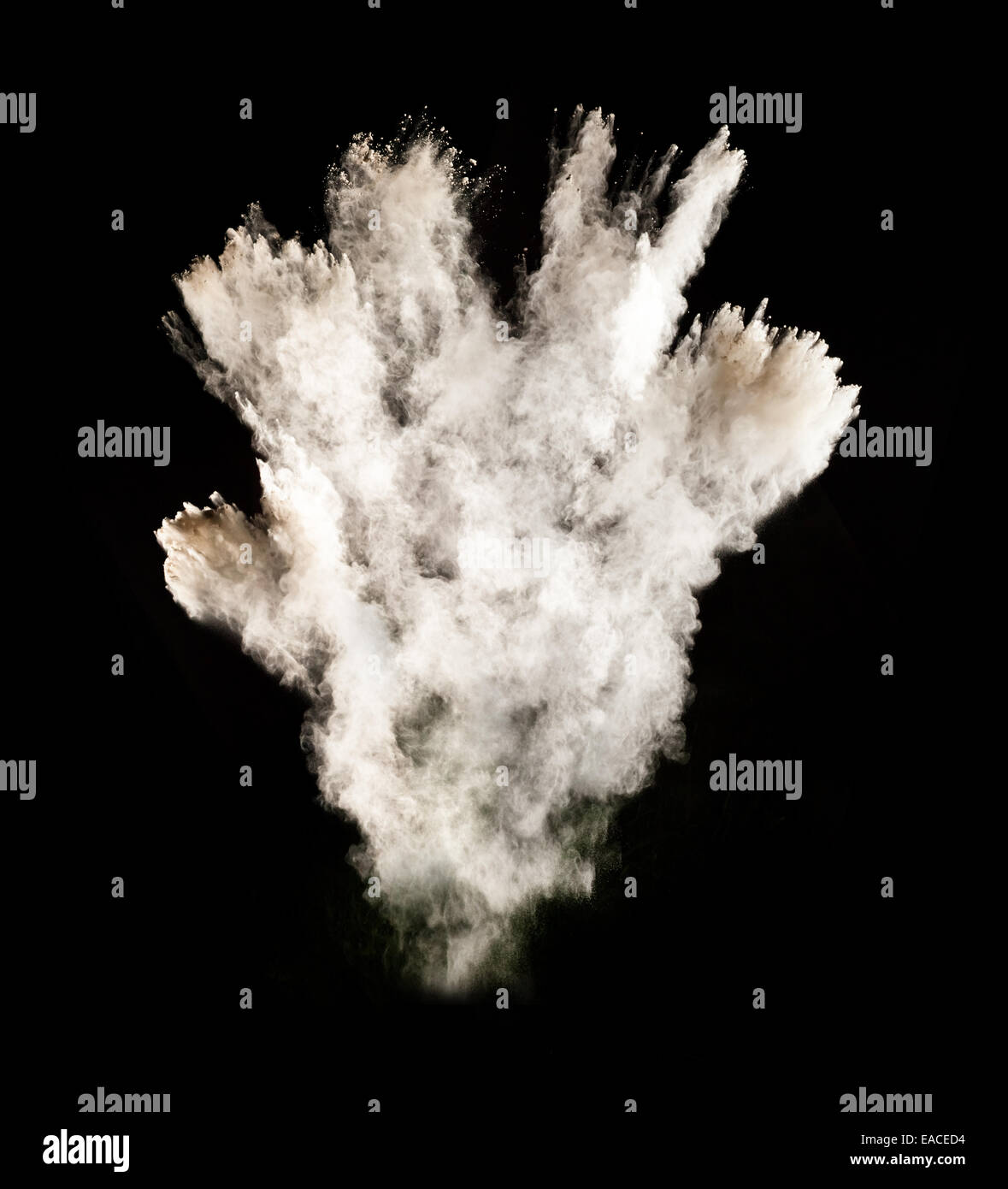 Freeze motion of white dust explosion isolated on black background Stock Photo