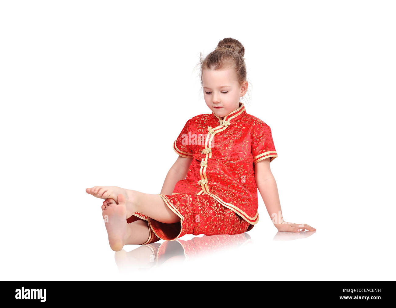European girl in traditional Chinese dress sitting on floor Stock Photo