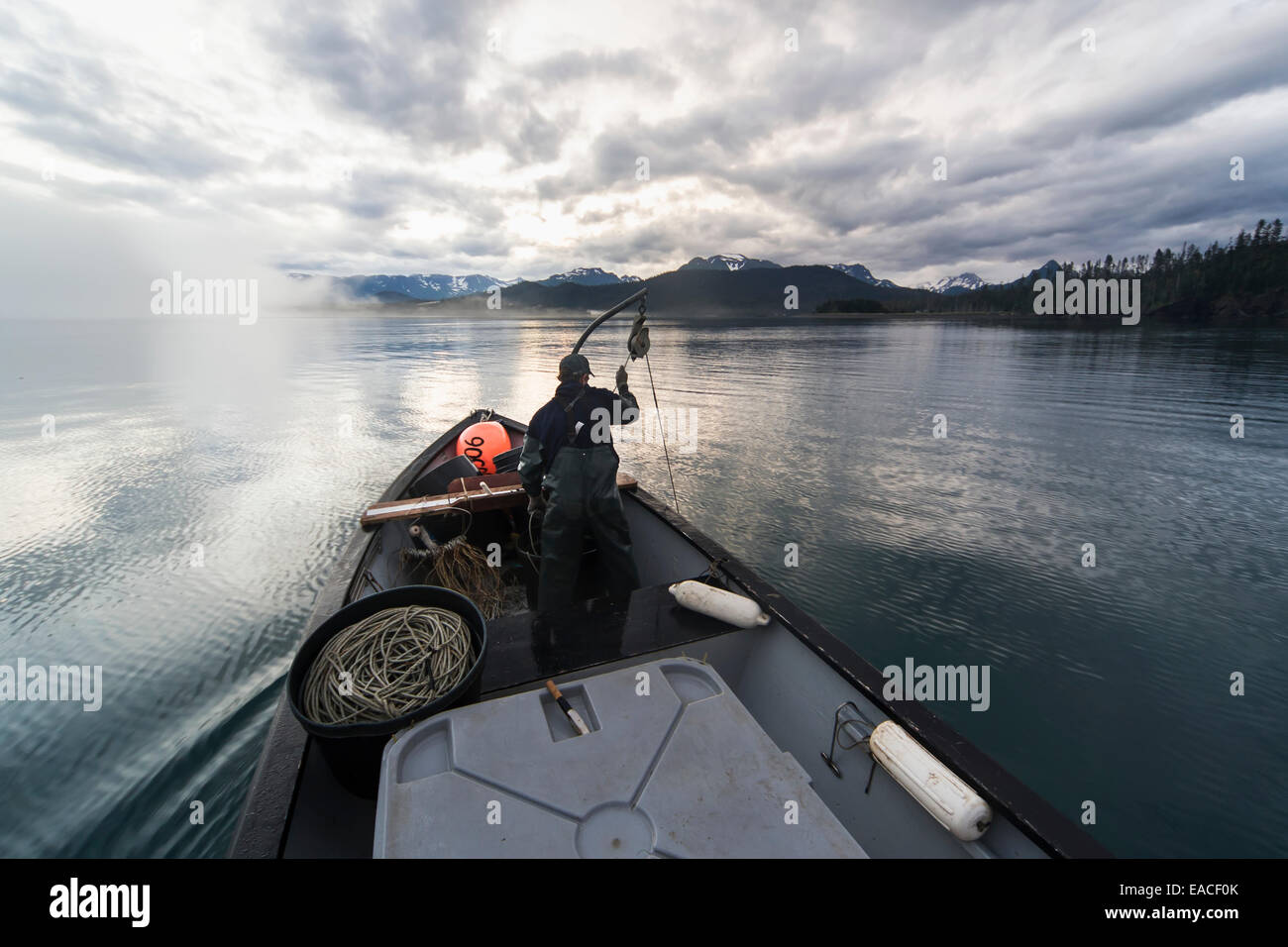 Commercial halibut fishing by hand using longline gear out of an open