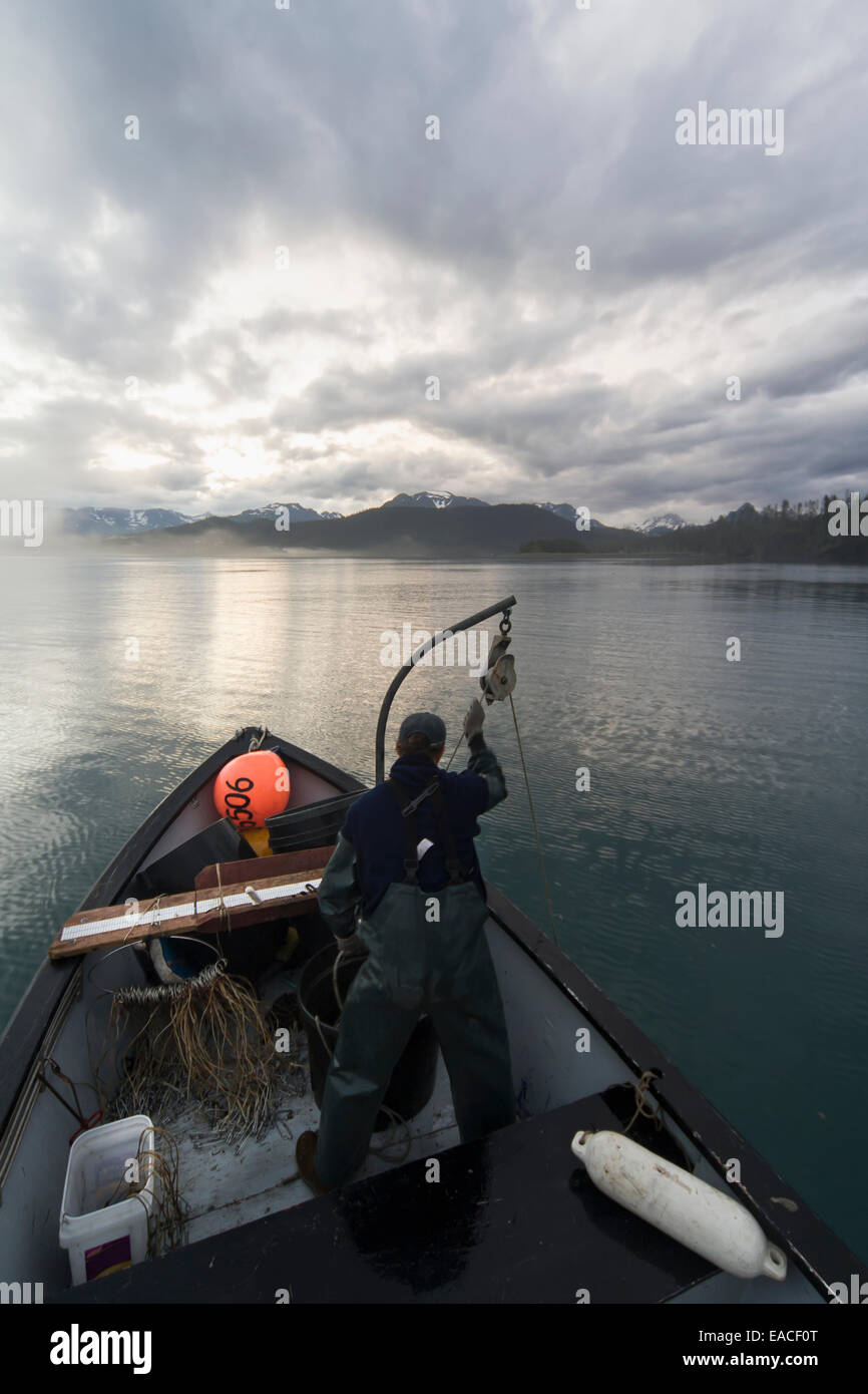 Commercial halibut fishing by hand using longline gear out of an open