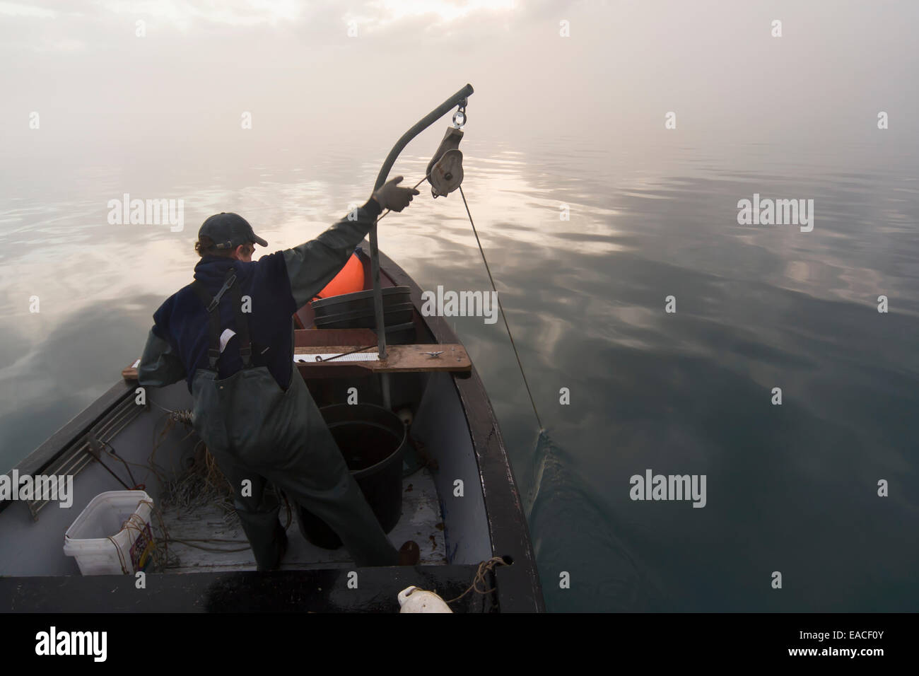 Commercial halibut fishing by hand using longline gear out of an open