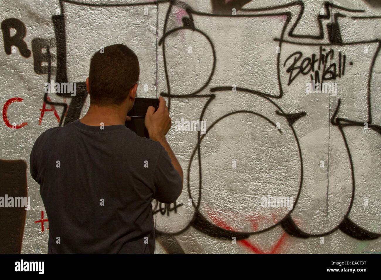 Graffiti street art Berlin wall tags tourist photo Stock Photo