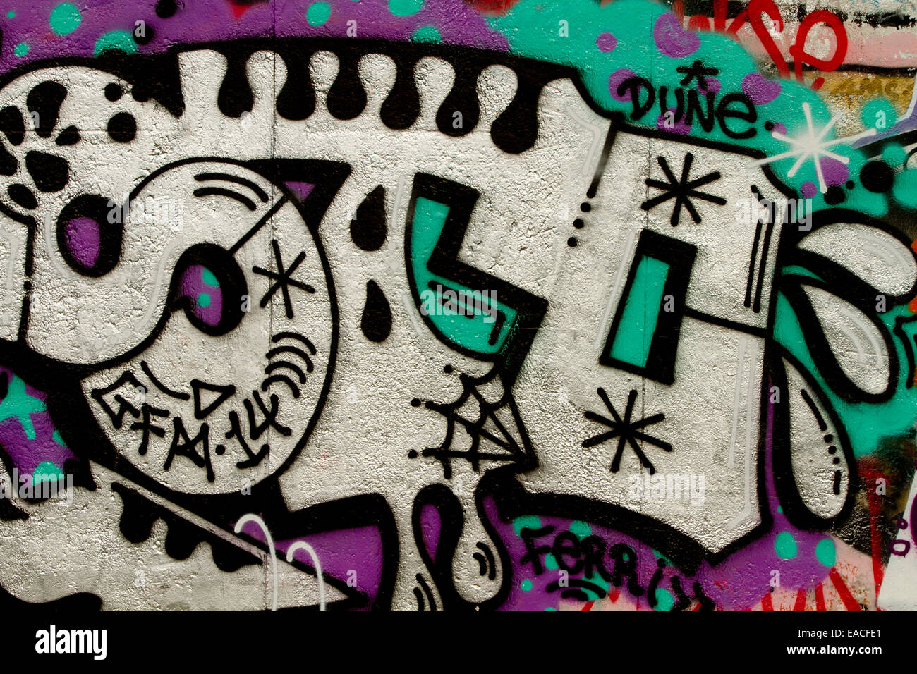 Graffiti street art Berlin wall tags cartoon letters Stock Photo
