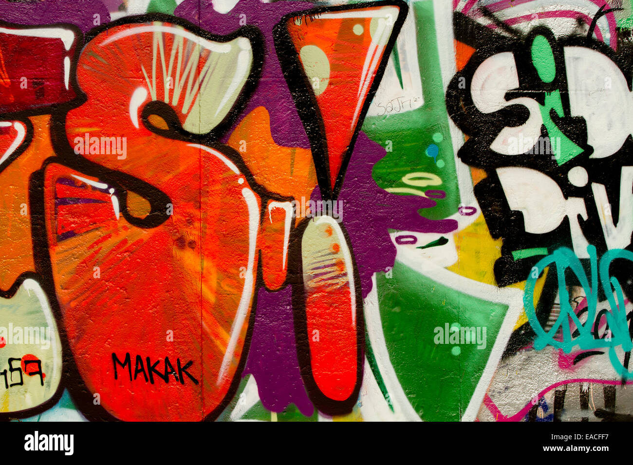 Graffiti street art Berlin wall tags cartoon letters Stock Photo
