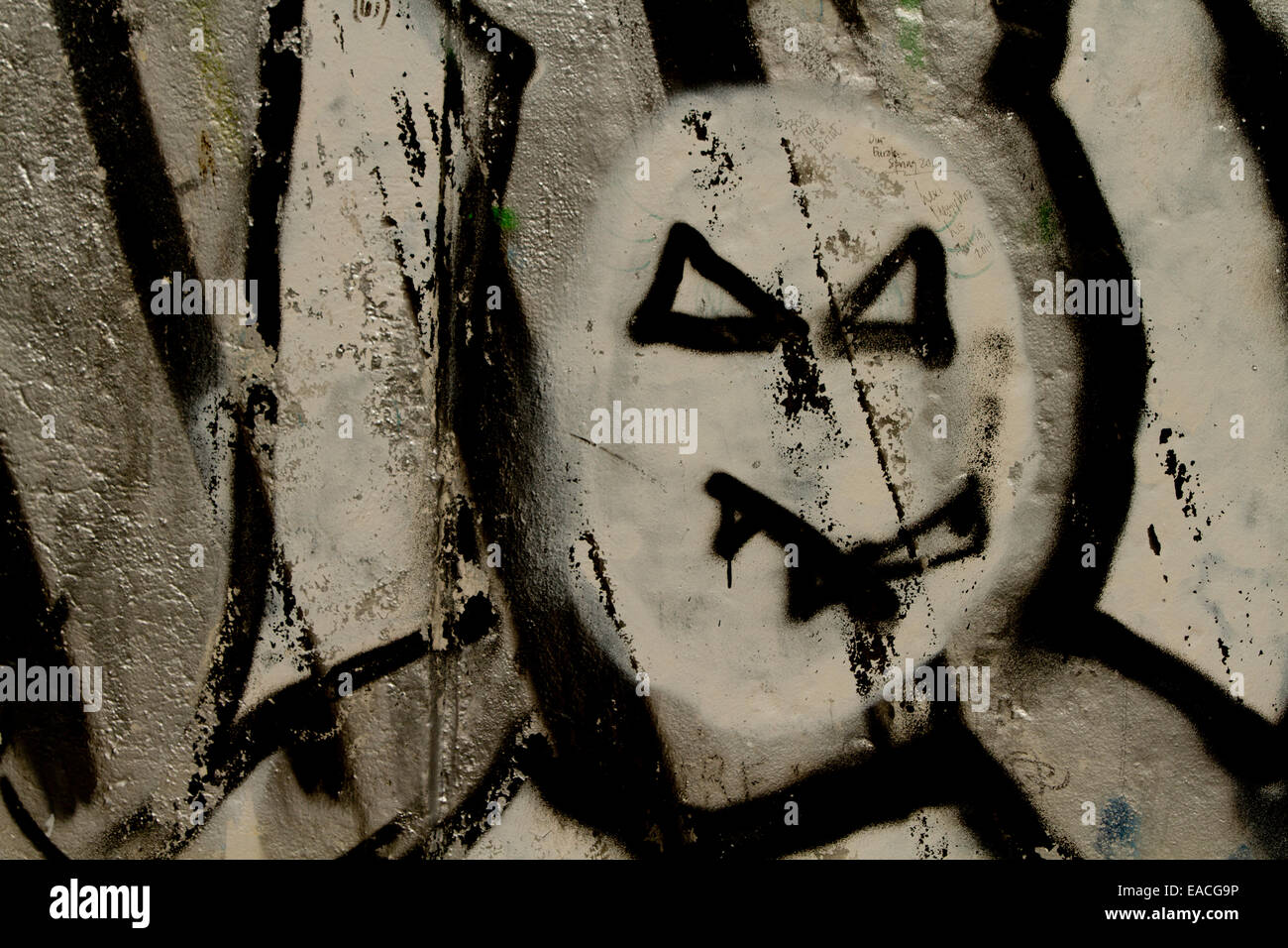 Graffiti street art Berlin wall horror face dark Stock Photo
