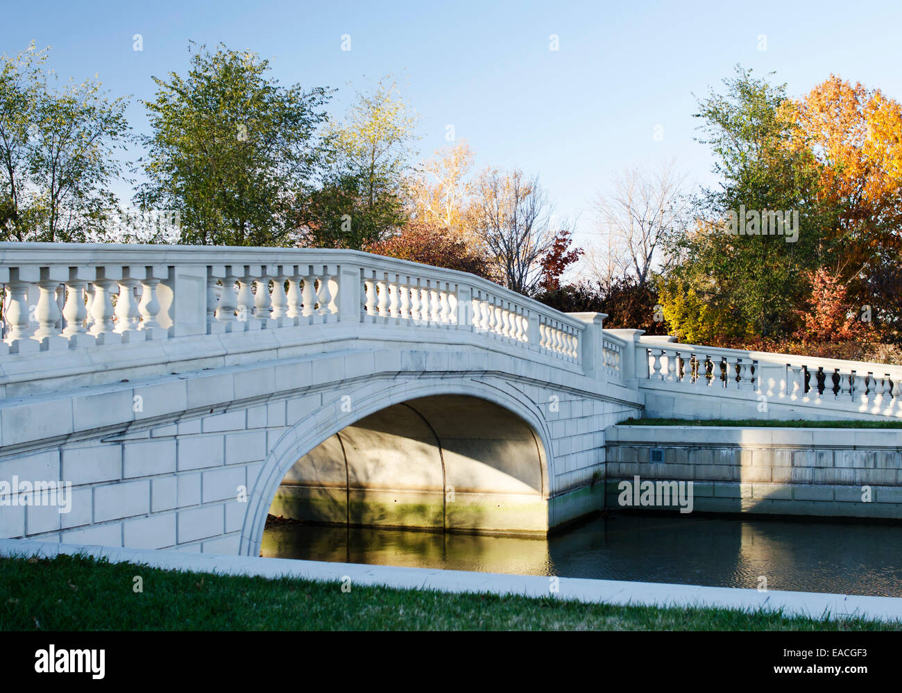 A bridge and lake in Forest Park at sunset Stock Photo