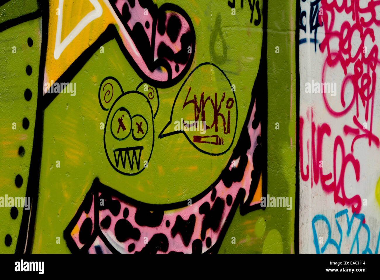 Graffiti cartoon face smoki joint colourful wall Stock Photo