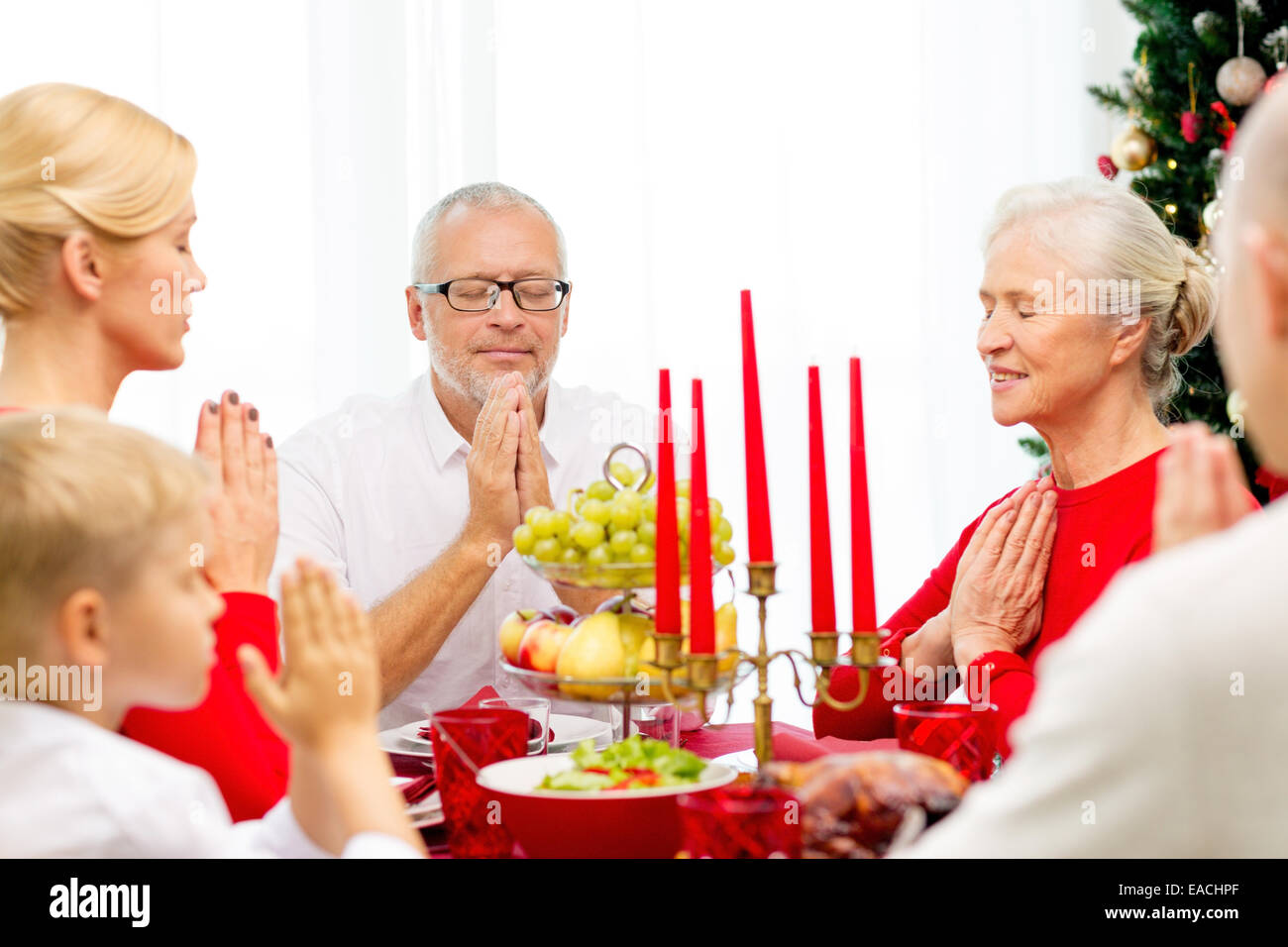 smiling family having holiday dinner at home Stock Photo - Alamy