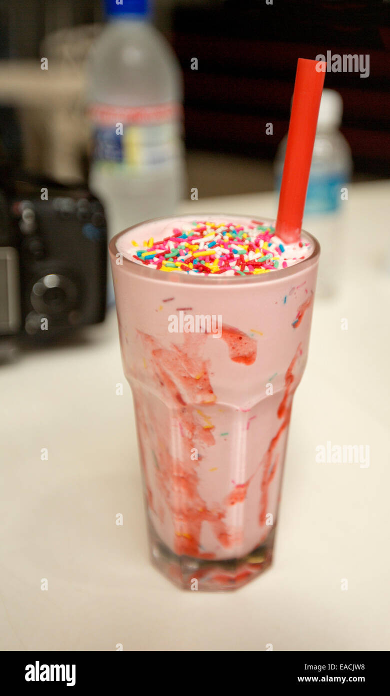 https://c8.alamy.com/comp/EACJW8/drinking-glass-filled-with-strawberry-milkshake-with-bright-red-straw-EACJW8.jpg