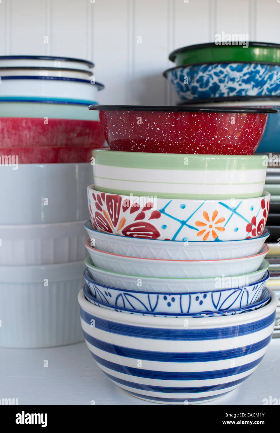 Pile of old dishes and bowls on a white shelf Stock Photo