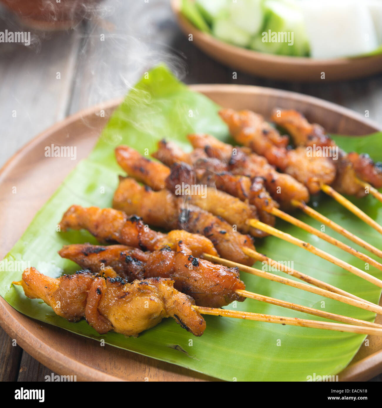 Yummy chicken sate or satay, skewered and grilled meat, served with peanut sauce. Fresh cooked with steamed and smoke. Hot and s Stock Photo