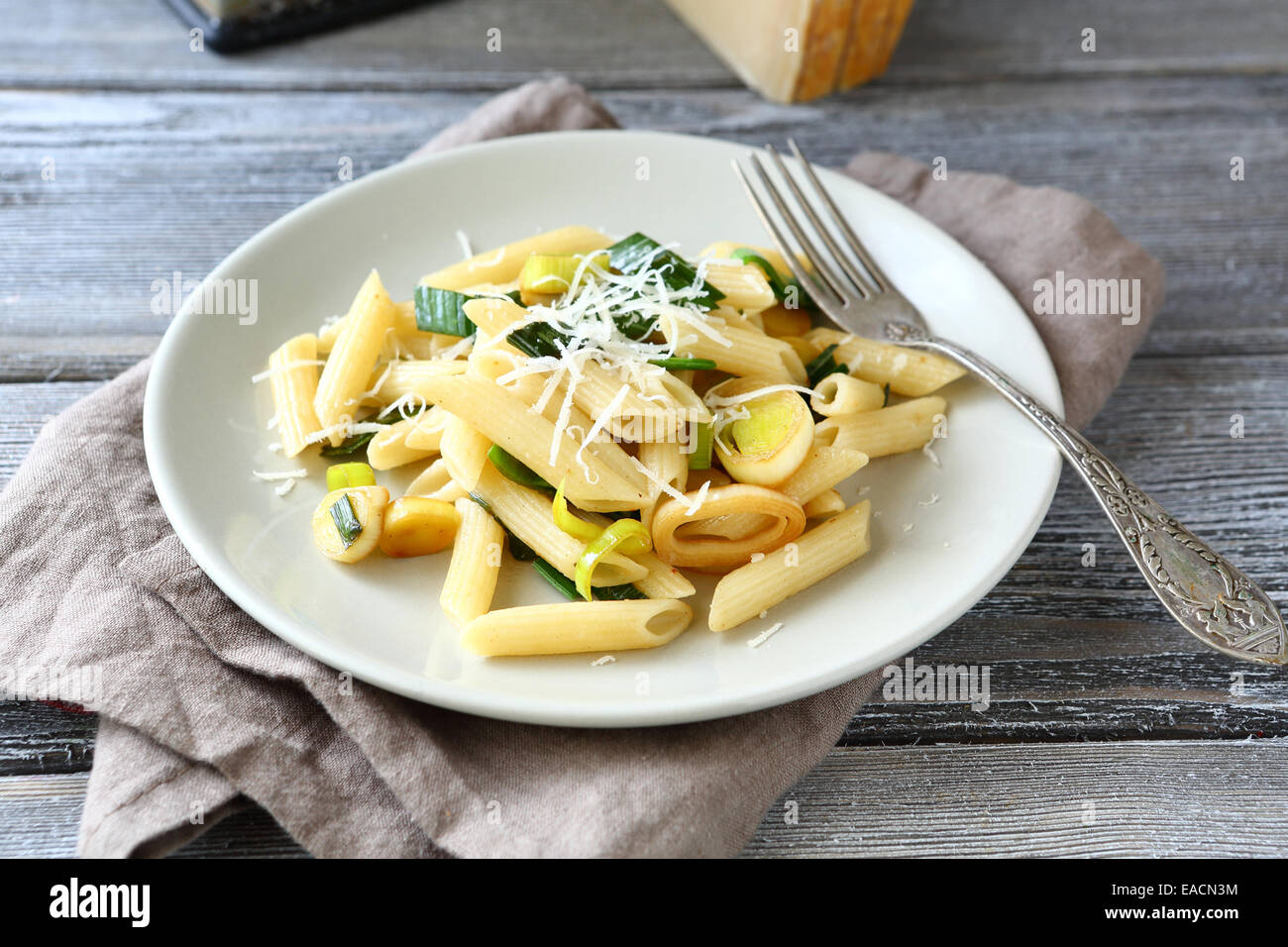 Tasty pasta with cheese and onions on a white plate, italian food Stock Photo