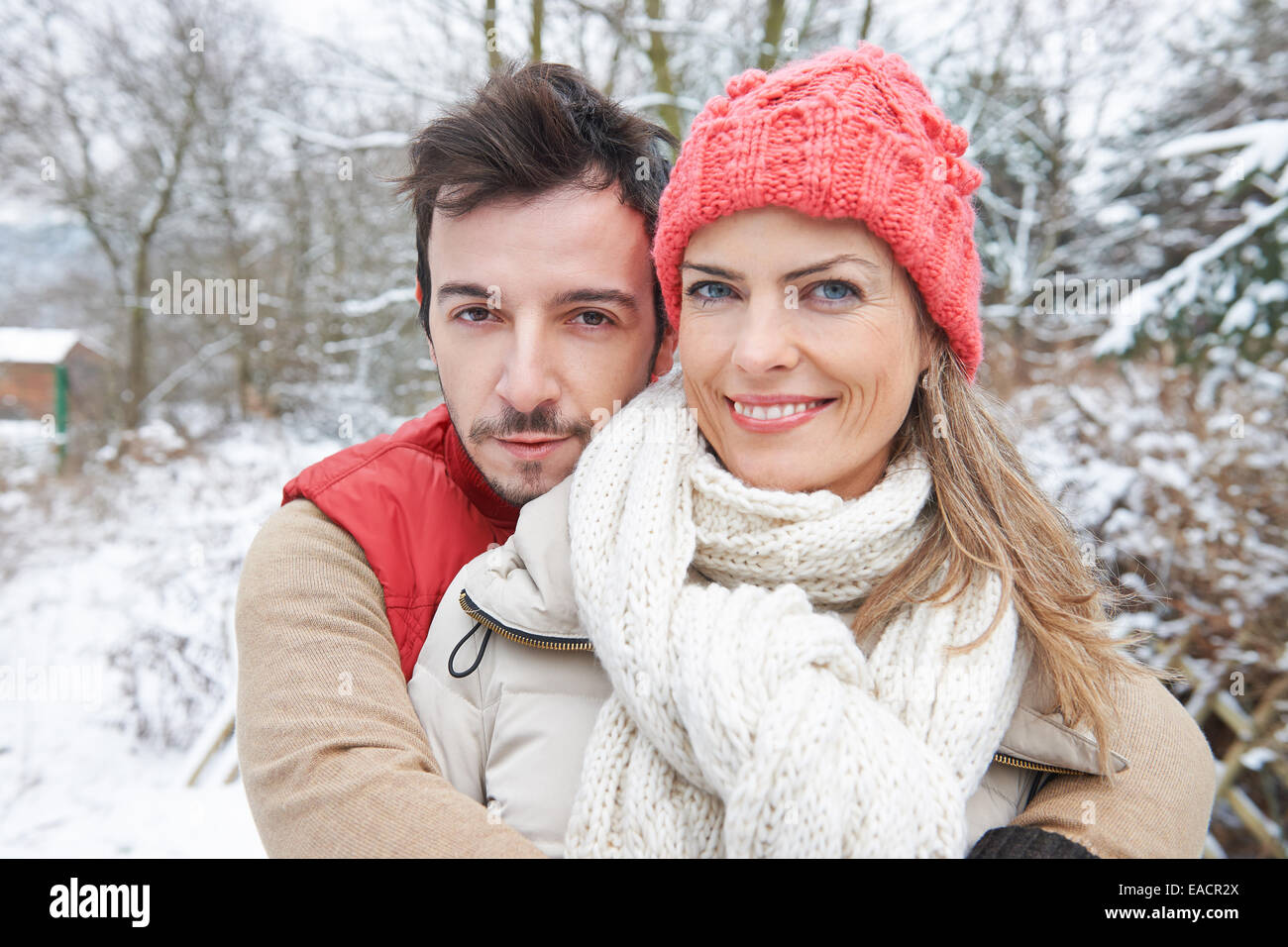 Happy smiling couple embracing in winter in snow landscape Stock Photo ...