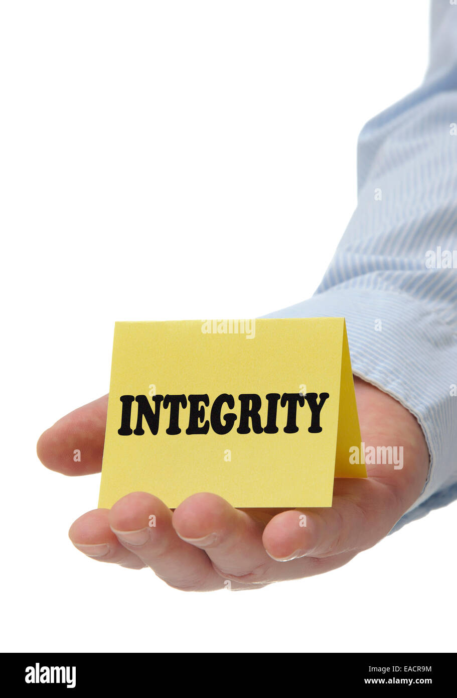 Business man holding yellow integrity sign on hand Stock Photo