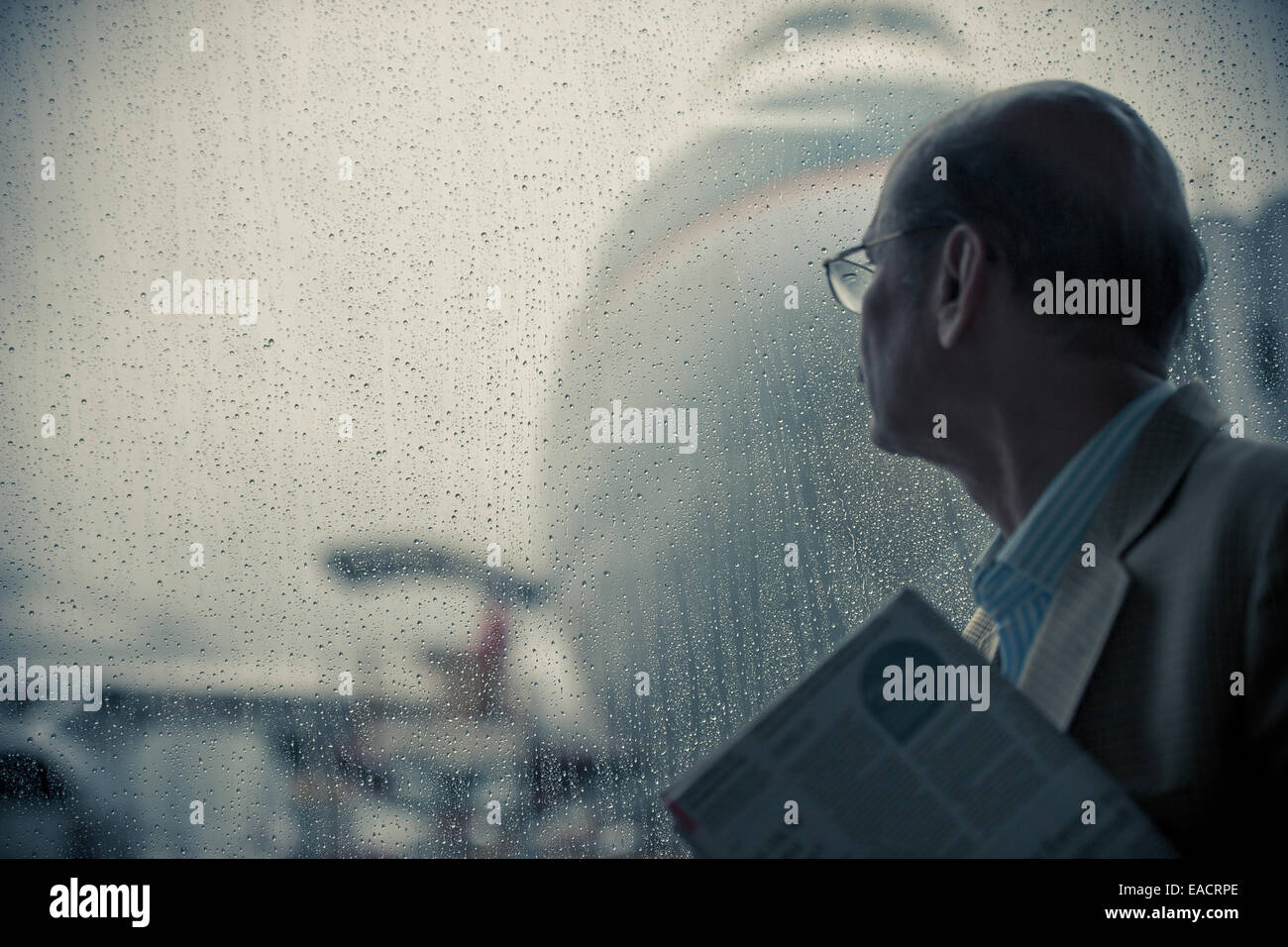 Man waiting to board his flight in an airport. Stock Photo