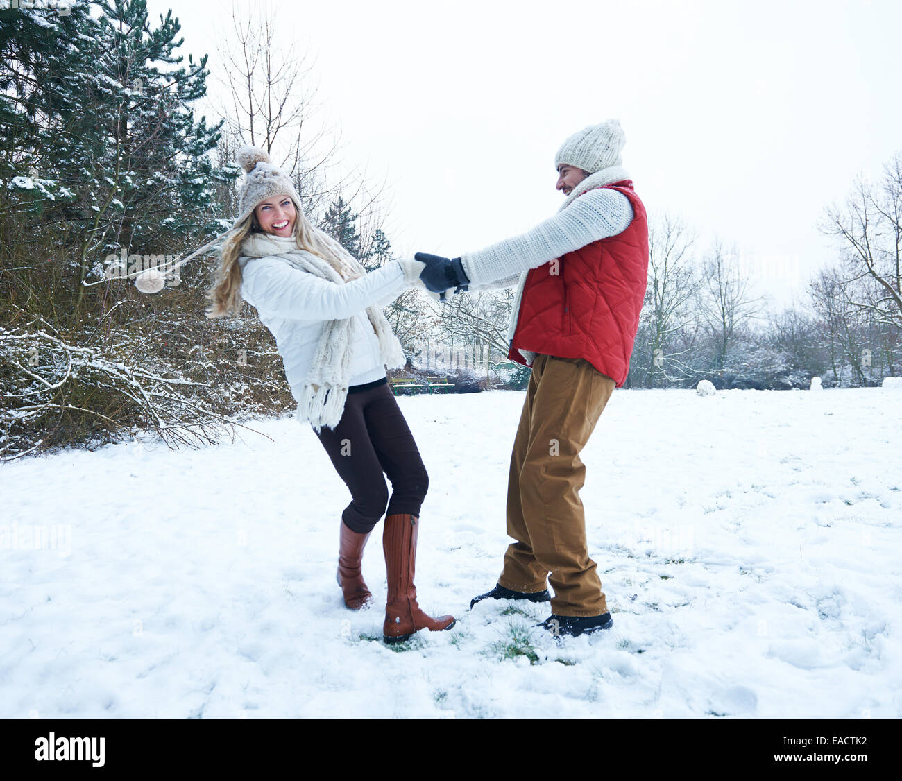 Happy couple dancing together in winter snow landscape Stock Photo