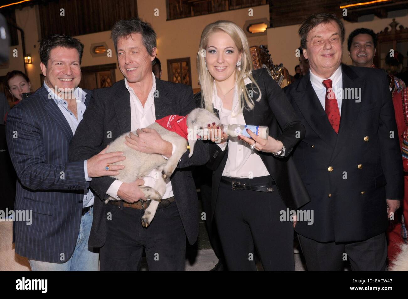 Salzburg, Austria. 11th Nov, 2014. Actor Francis Fulton-Smith (L-R), British actor Hugh Grant, Kathrin Glock, wife of weapons manufacturer Glock, and Michael Aufhauser, owner of Gut Aiderbichl, pose with a lamb at a traditional Christmas display at the Gut Aiderbichl animal sanctuary in Salzburg, Austria. On 06 December 2014 the show 'Advent in Aiderbichl' will be broadcast on the television station ORF 2 with a report on the Christmas display. The animal sanctuary is home to animals who come from sad situations. Credit:  dpa picture alliance/Alamy Live News Stock Photo