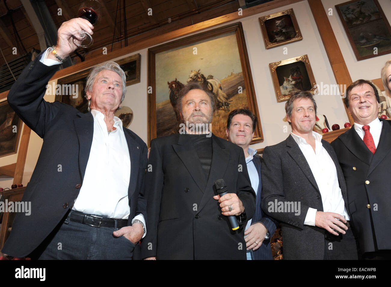 Salzburg, Austria. 11th Nov, 2014. Actors Alain Delon (L-R), Franco Nero, Francis Fulton-Smith, Hugh Grant, and Michael Aufhauser, owner of Gut Aiderbichl, at a traditional Christmas display at the Gut Aiderbichl animal sanctuary in Salzburg, Austria. On 06 December 2014 the show 'Advent in Aiderbichl' will be broadcast on the television station ORF 2 with a report on the Christmas display. The animal sanctuary is home to animals who come from sad situations. Credit:  dpa picture alliance/Alamy Live News Stock Photo