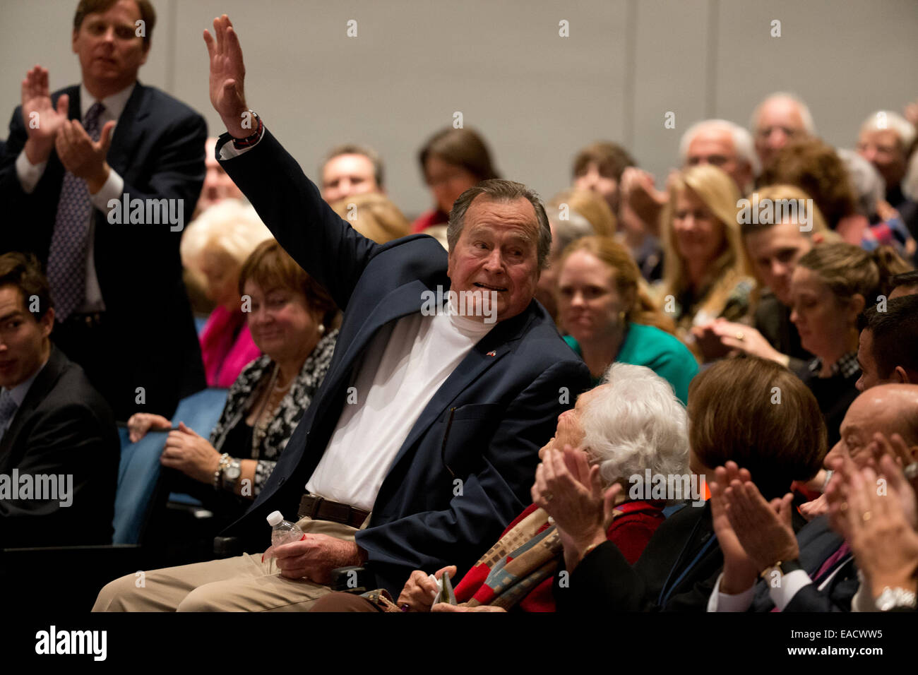 College Station, Texas, USA. 11th November, 2014. Former U.S. President George H. W. Bush waves while sitting with wife Barbara Bush as his son former President George W. Bush talks about his new book, '41 A Portrait of My Father'  during a book event at the Bush Library at Texas A&M University. Credit:  Bob Daemmrich/Alamy Live News Stock Photo