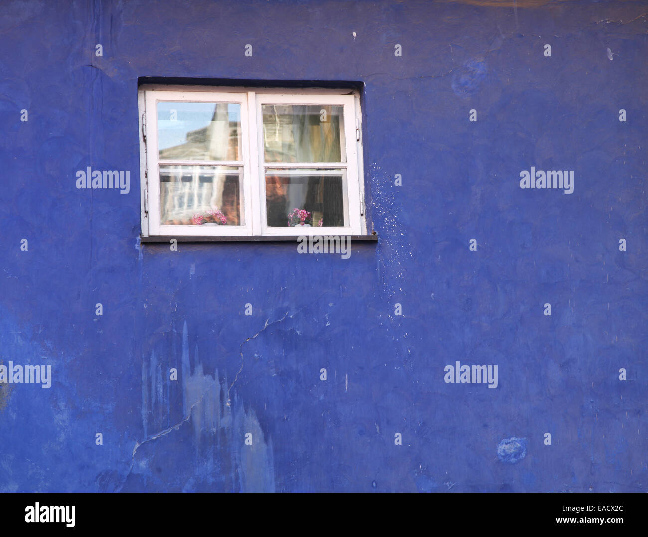 Small old window in the old blue building. Stock Photo