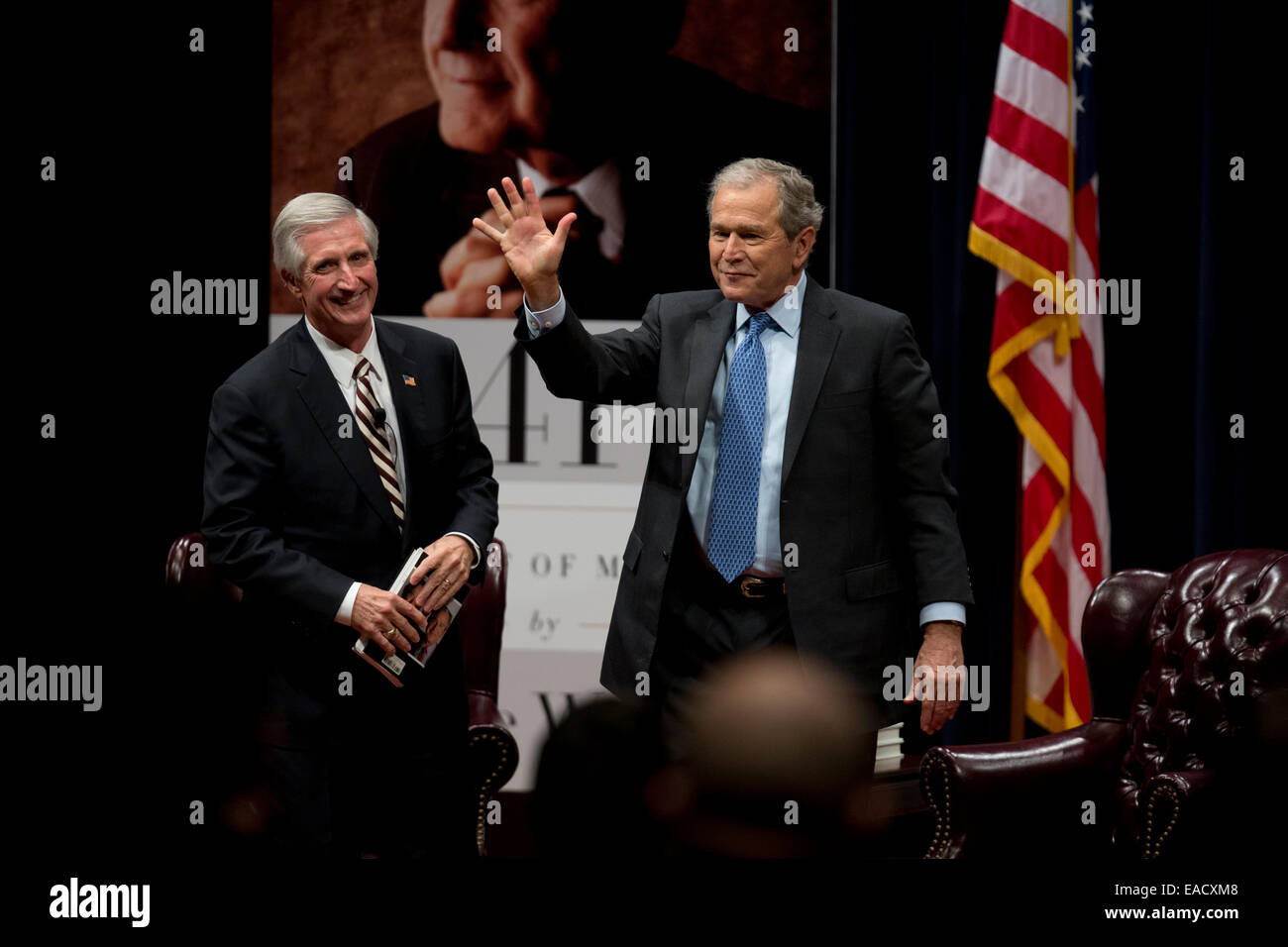 College Station, Texas, USA. 11th November, 2014. Former U.S. President George W. Bush, r,  waves after talking about his new book, '41 A Portrait of My Father' wiith former chief of staff Andrew Card during a book event at the Bush Library at Texas A&M University. The elder George H.W. Bush and wife Barbara were in the audience. Credit:  Bob Daemmrich/Alamy Live News Stock Photo