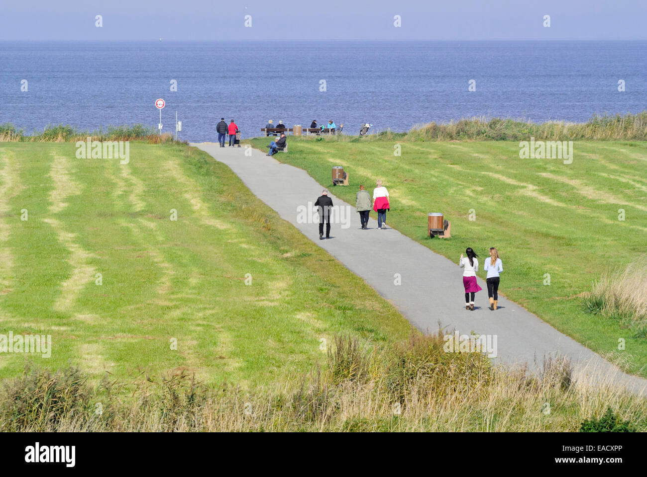 Promenaders at Elbe River Mouth near Otterndorf, Germany Stock Photo