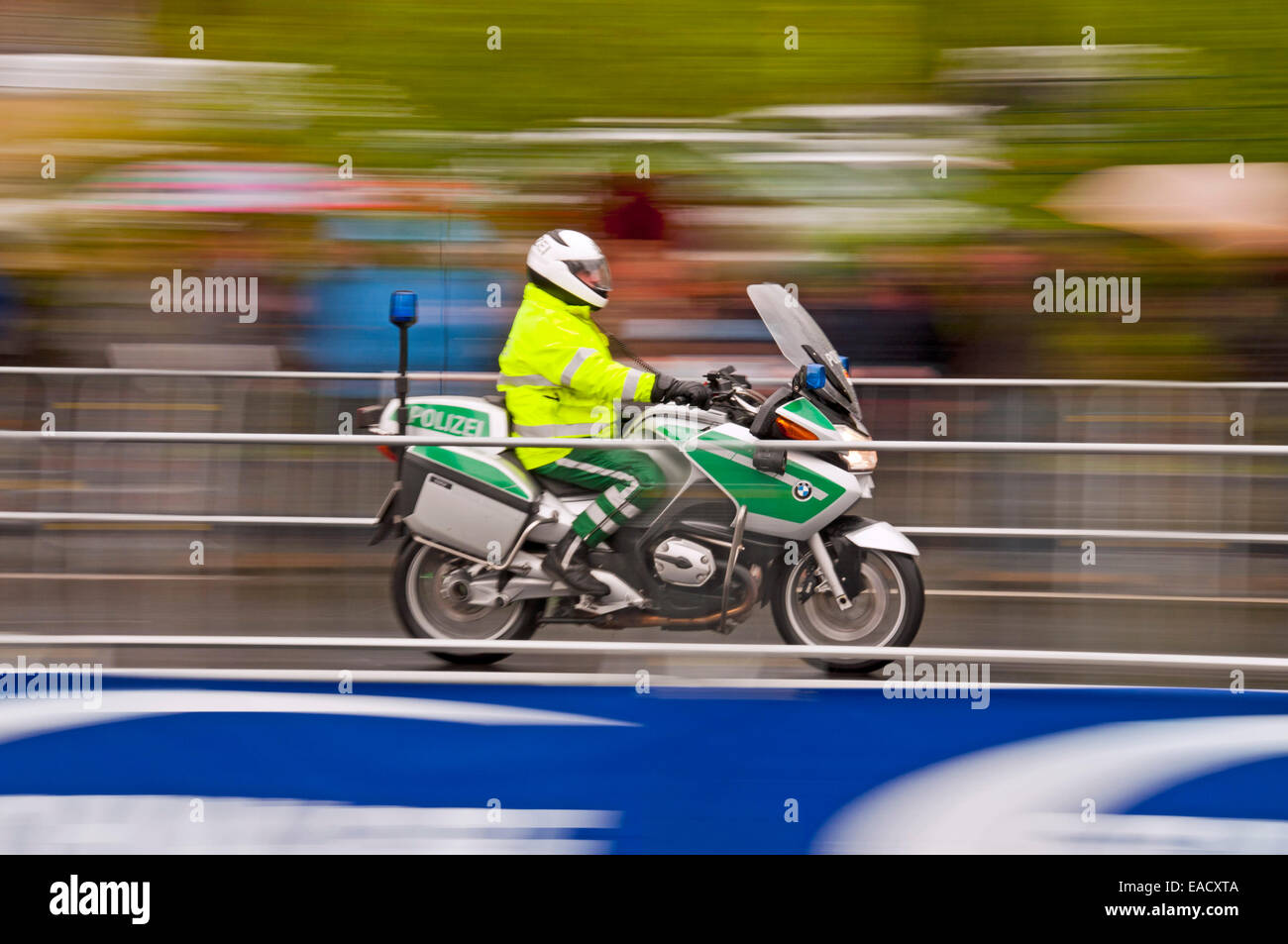 Accompanying motorcycle of the Rund um Koeln cycling race during rainy weather, Cologne, Rhineland, North Rhine-Westphalia Stock Photo