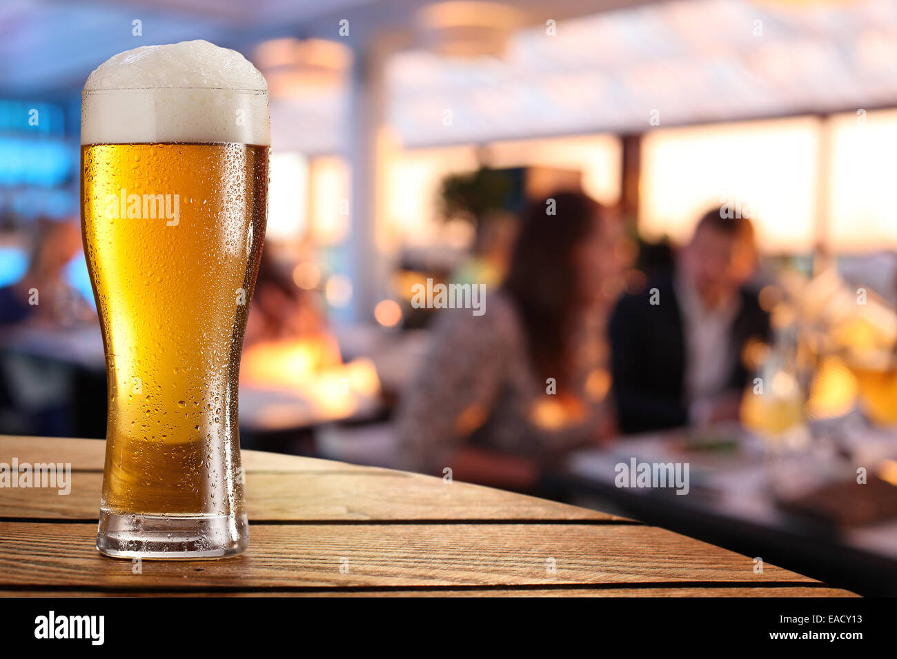 Photo of cold beer glass on the bar table. Stock Photo