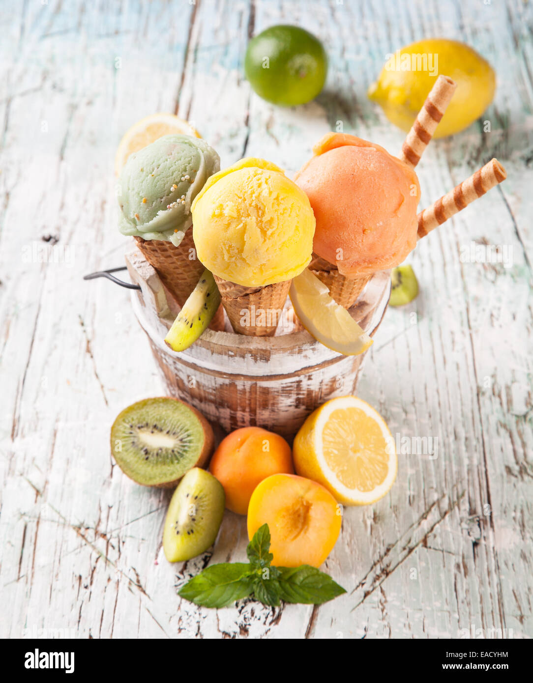 Studio photo of ice cream scoops in waffle cones. Served on wooden ...