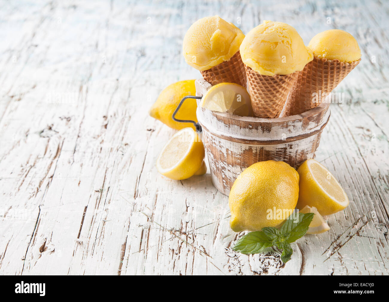 Studio photo of ice cream scoops in waffle cones. Served on wooden ...