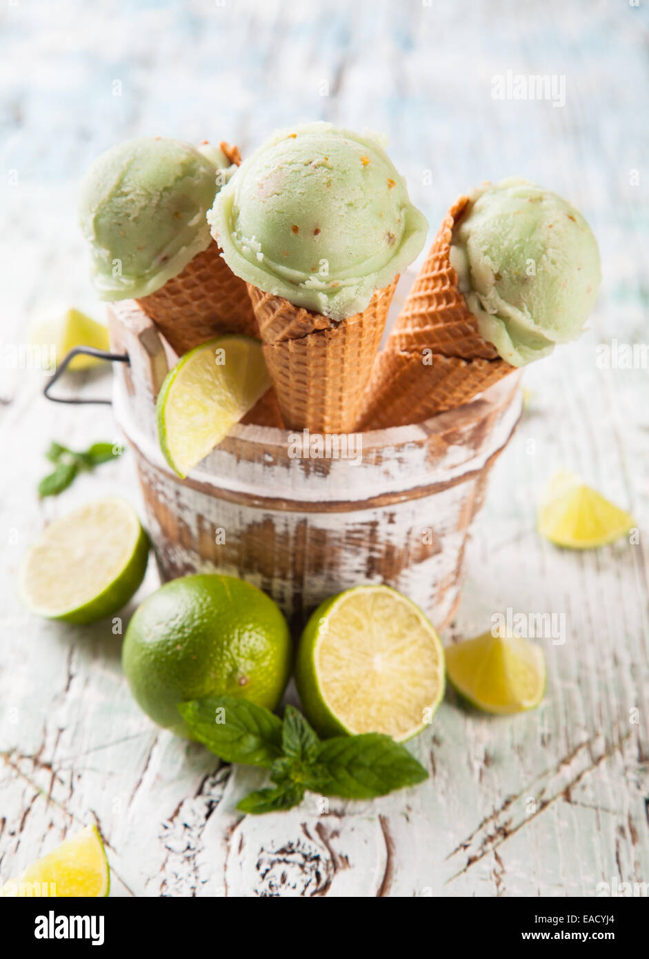Studio photo of ice cream scoops in waffle cones. Served on wooden ...