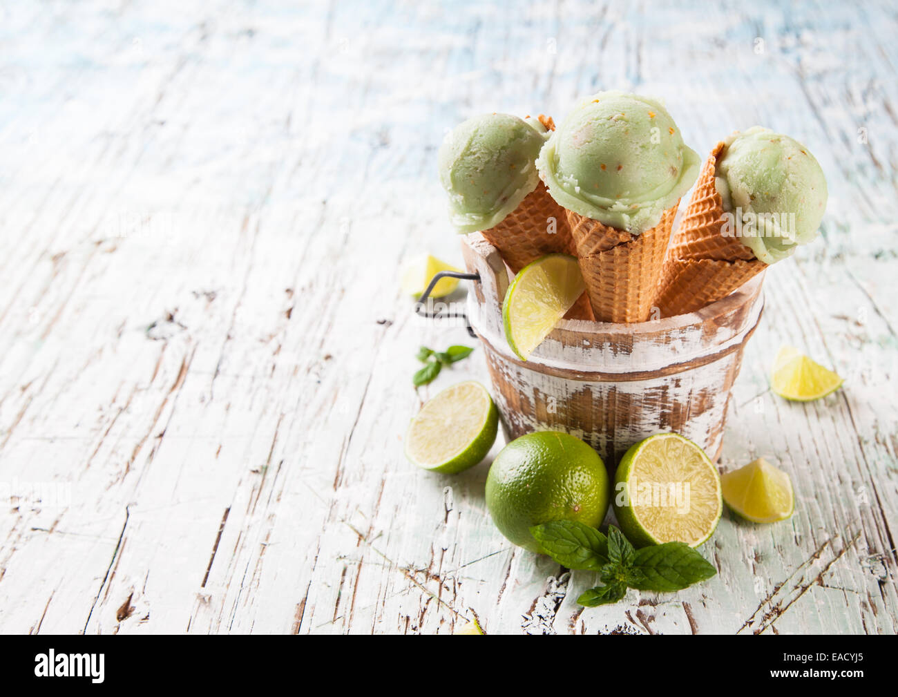 Studio photo of ice cream scoops in waffle cones. Served on wooden ...