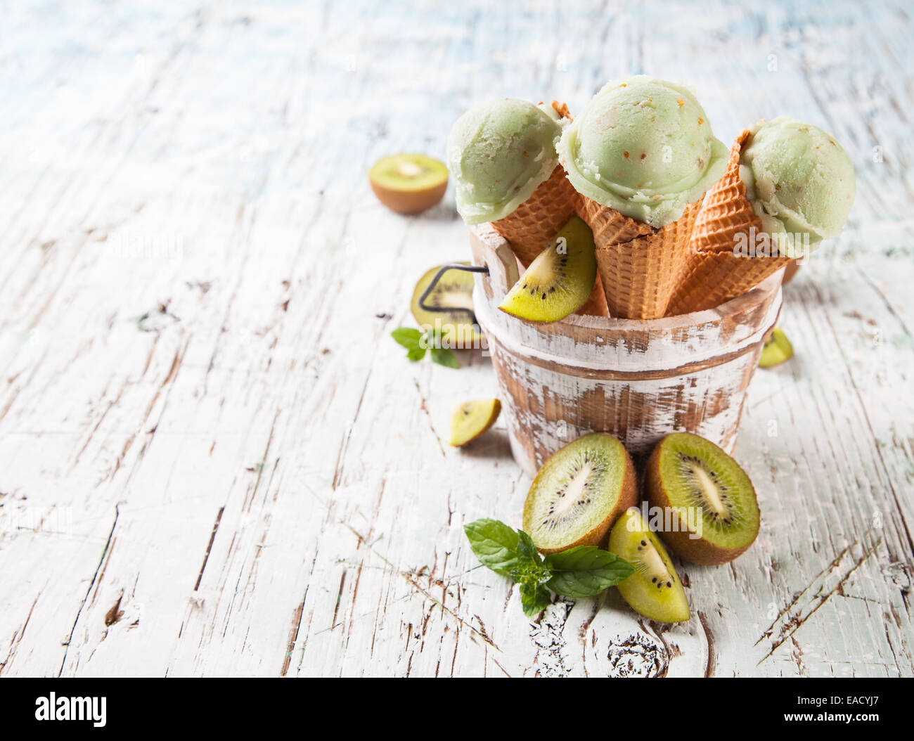 Studio photo of ice cream scoops in waffle cones. Served on wooden ...