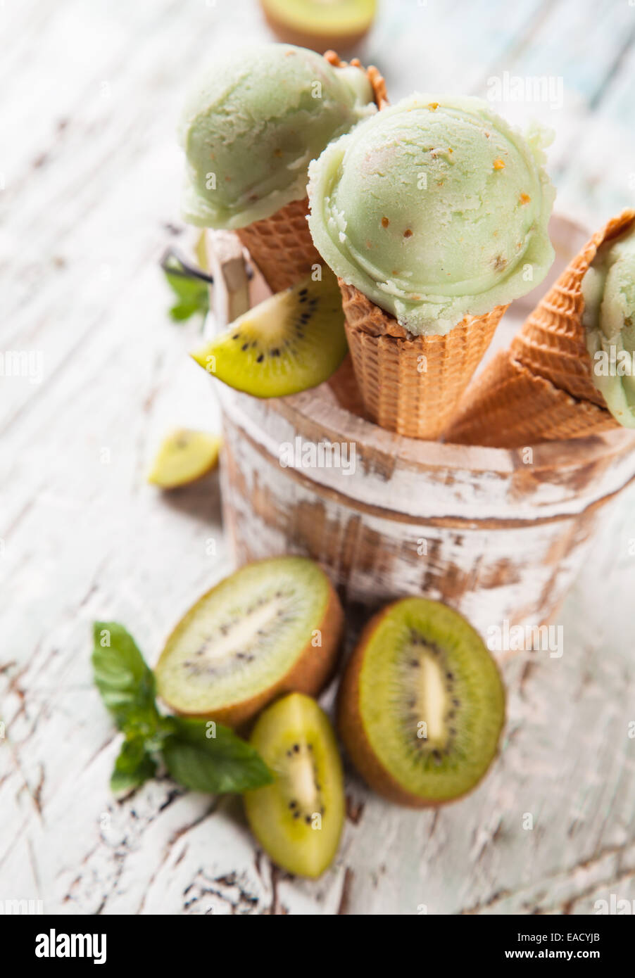 Studio photo of ice cream scoops in waffle cones. Served on wooden ...