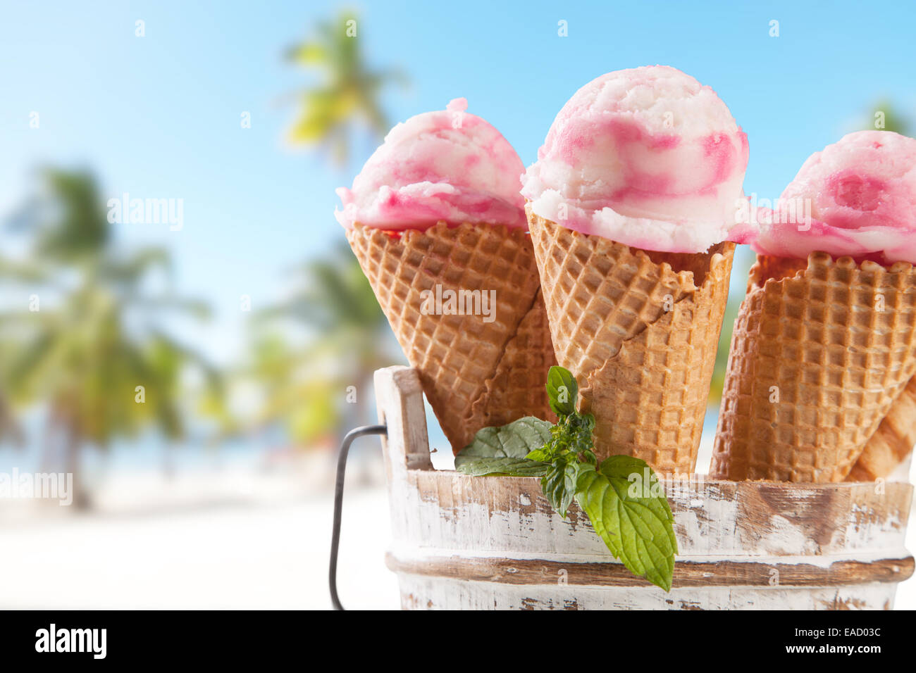 Fruit ice cream with blur beach as background. Served on wooden planks Stock Photo