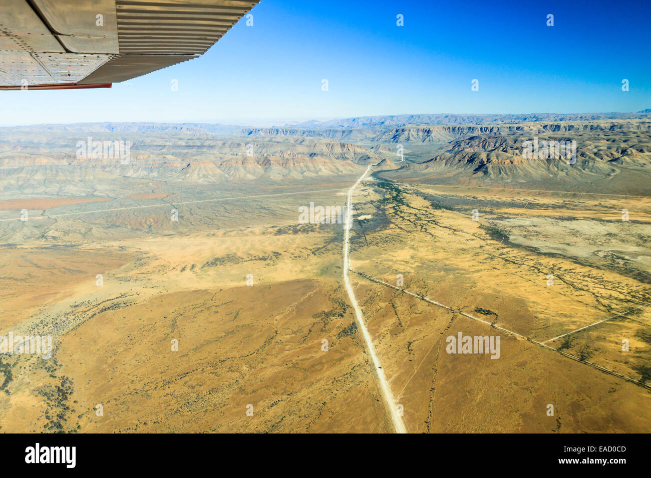 View from a small plane over the sand road C26, disappearing between the mountains in the direction of Gamsberg Pass Stock Photo