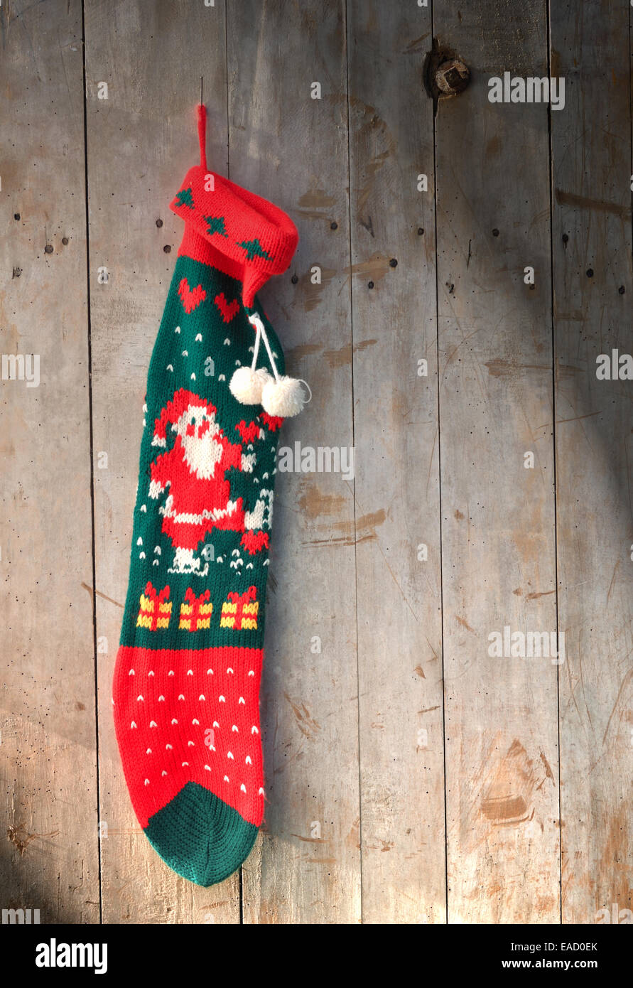 woolen sock christmas hanging on wooden background Stock Photo
