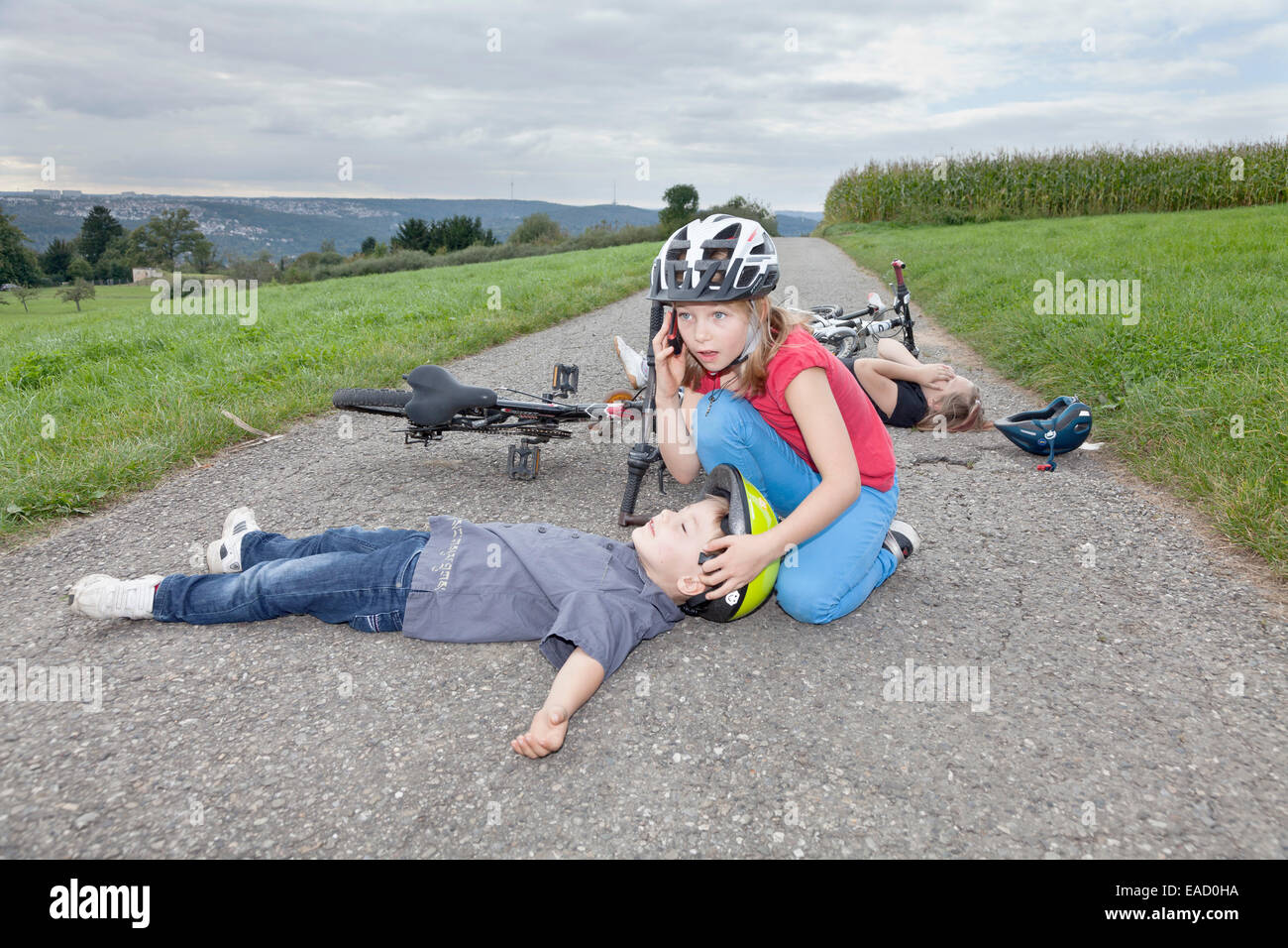 Girl, 9 years, phoning for help after a bicycle accident Stock Photo