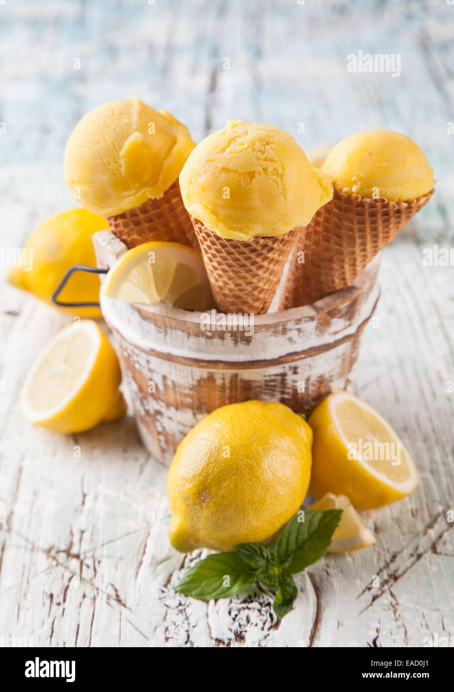 Studio photo of ice cream scoops in waffle cones. Served on wooden ...