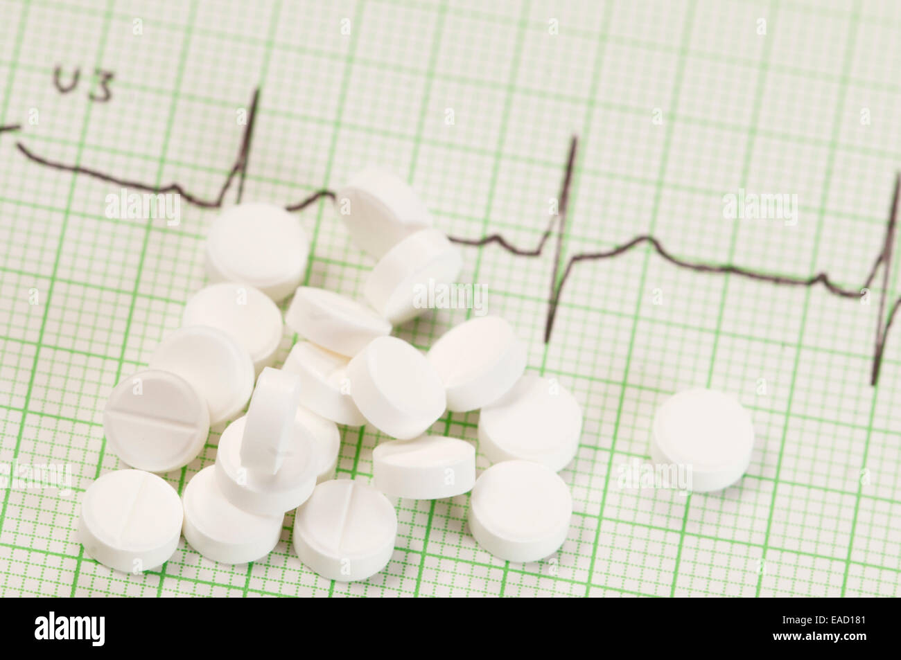 Tablets on electrocardiogram paper, closeup shot, local focus Stock Photo