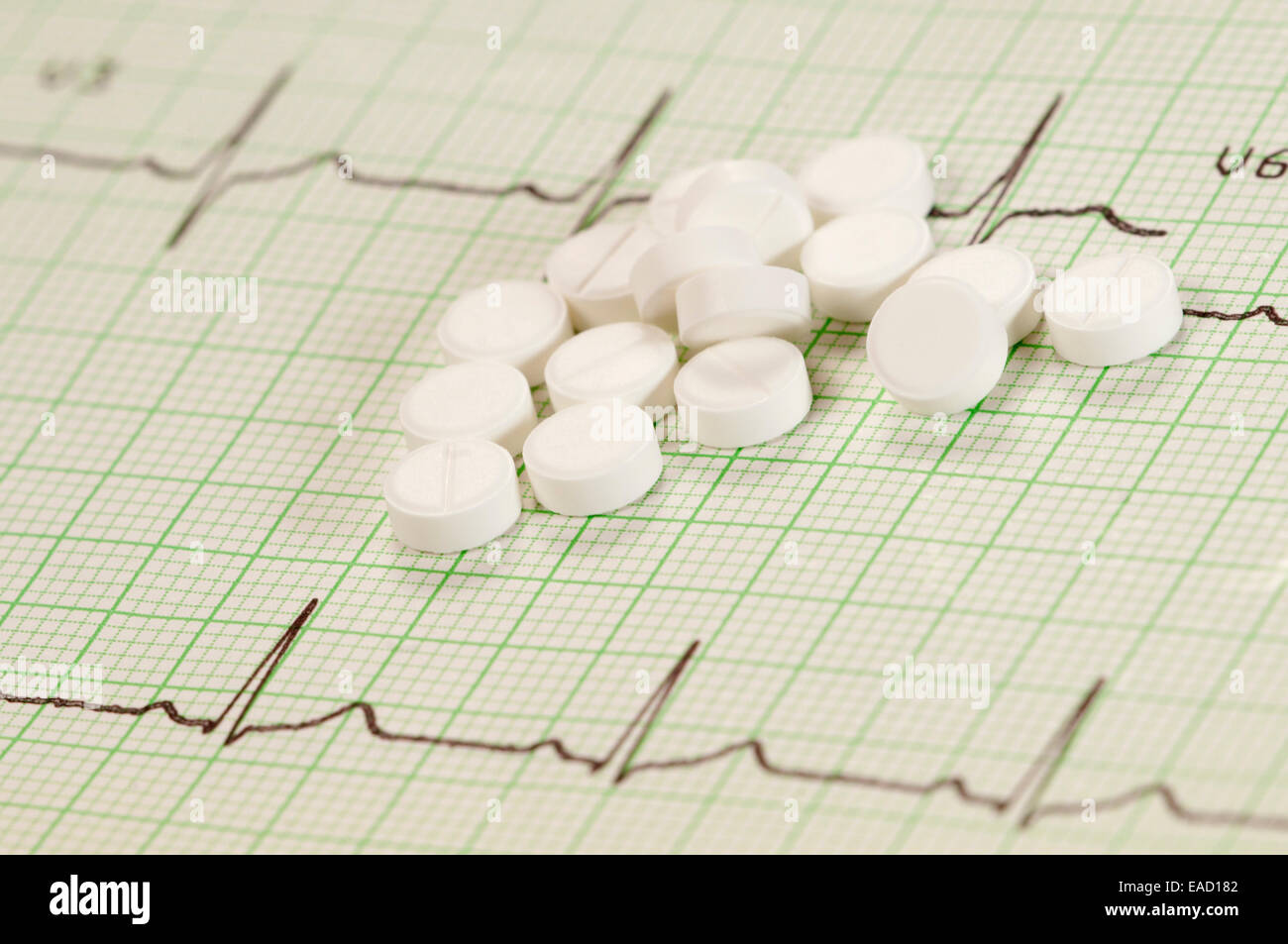 Tablets on electrocardiogram paper, closeup shot, local focus Stock Photo