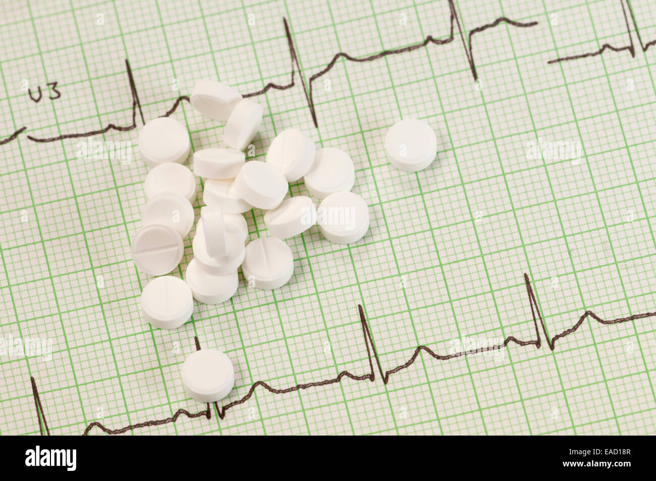 Tablets on electrocardiogram paper, closeup shot, local focus Stock Photo